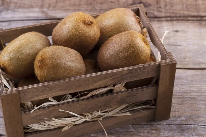 Framed Print : Box of fresh kiwi in on wooden background