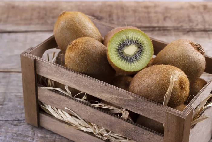 Framed Print : Box of fresh kiwi in on wooden background