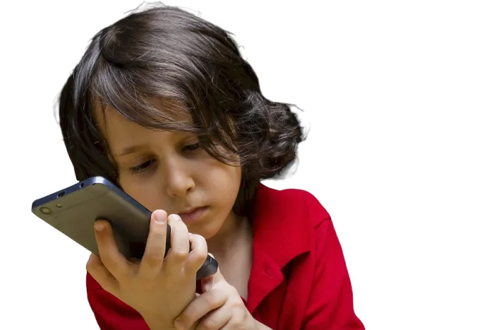 Framed Print : Boy with mobile phone in hand isolated on a white background Framed Print : Boy with mobile phone in hand isolated on a white background