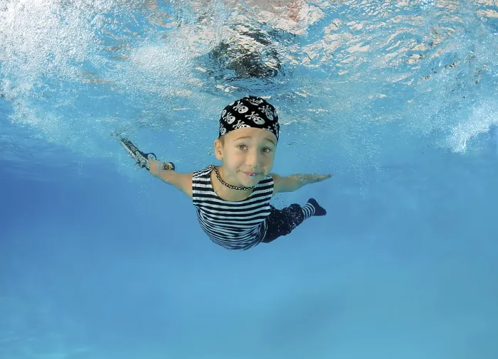 Framed Print : Boy presenting underwater fashion in pool Framed Print : Boy presenting underwater fashion in pool