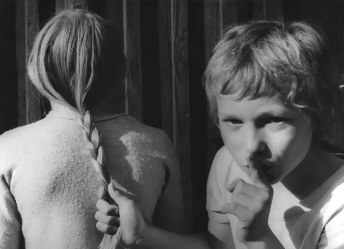 Framed Print : Boy pulls girls by the hair about 1970s Framed Print : Boy pulls girls by the hair about 1970s