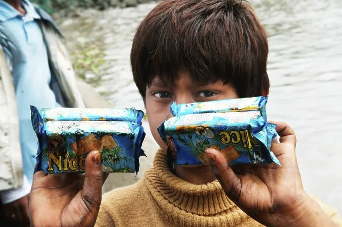 Framed Print : Boy showing oil soaked biscuit packets due to container ship chitra colliding in sea Mumbai Framed Print : Boy showing oil soaked biscuit packets due to container ship chitra colliding in sea Mumbai