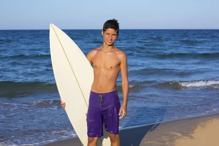 Framed Print : Boy teen surfer happy holing surfboard on the beach shore Framed Print : Boy teen surfer happy holing surfboard on the beach shore