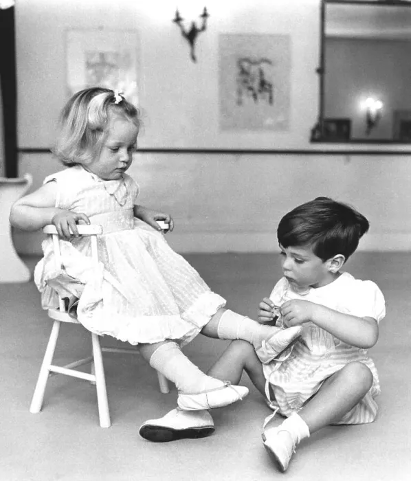 Framed Print : Boy ties up girls shoes, England, Great Britain Framed Print : Boy ties up girls shoes, England, Great Britain