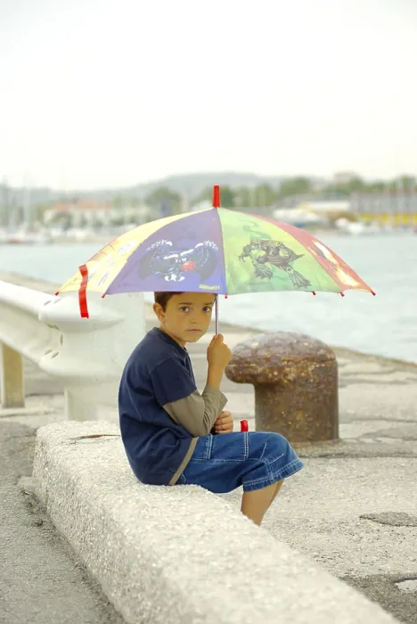 Framed Print : Boy with umbrella at pier, Pesaro, umbrella, Italy