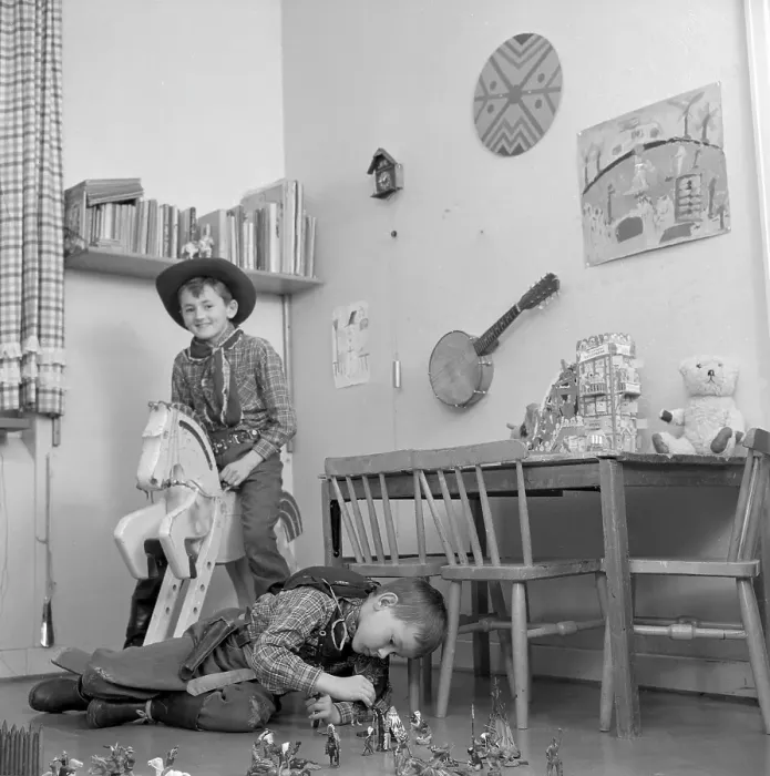 Framed Print : Boys in the 1950s. Two boys in their play room are dressed as cowboys