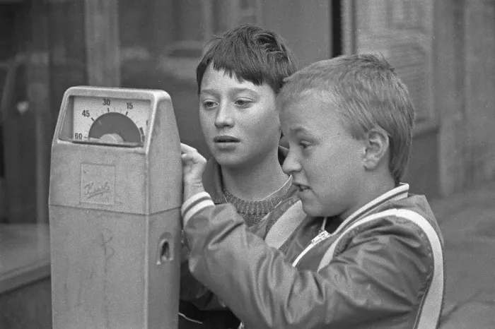 Framed Print : Two boys examining a parking meter Framed Print : Two boys examining a parking meter