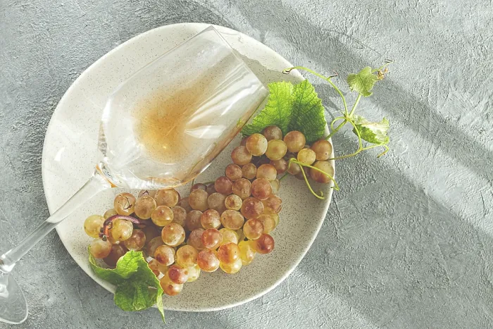 Framed Print : A branch of white grapes, on a gray plate Framed Print : A branch of white grapes, on a gray plate