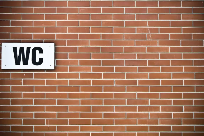 Framed Print : A brick wall with a WC sign mounted on it Framed Print : A brick wall with a WC sign mounted on it