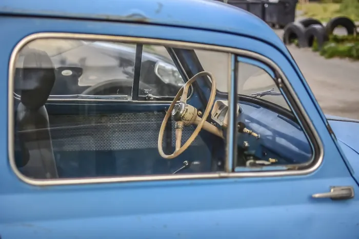 Framed Print : Side part of bright blue old automobile with wheel in window Framed Print : Side part of bright blue old automobile with wheel in window