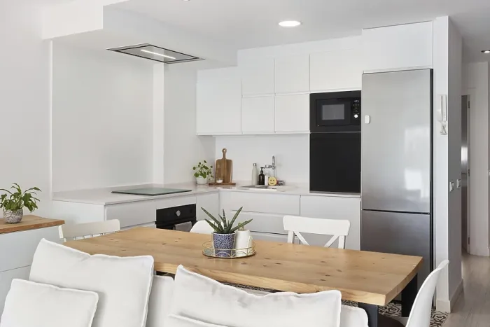 Framed Print : Bright and modern kitchen with sleek white cabinets and stainless steel appliances in the city center Framed Print : Bright and modern kitchen with sleek white cabinets and stainless steel appliances in the city center
