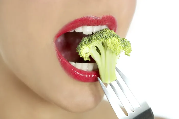 Framed Print : Broccoli on steel fork in woman mouth with red lips