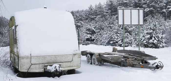 Framed Print : Broken tourist car trailer covered with snow in the winter forest landscape