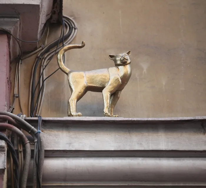 Framed Print : Bronze figure a cat on the ledge of the house Framed Print : Bronze figure a cat on the ledge of the house