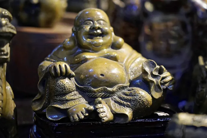 Framed Print : Bronze sculpture of a smiling seated Buddha