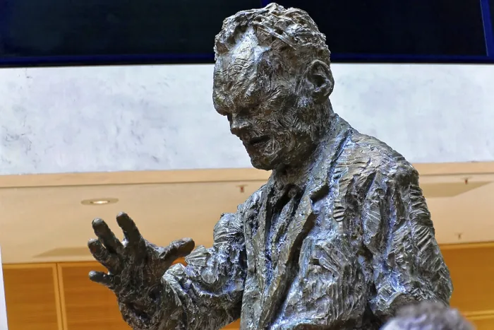 Framed Print : Bronze statue of a man in a modern lobby of a building