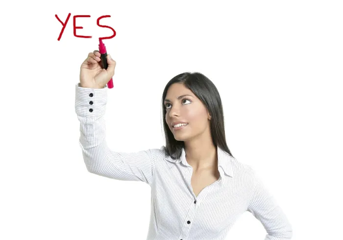 Framed Print : Brunette businesswoman writing word YES on a copyspace