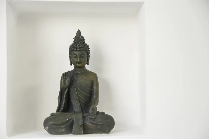 Framed Print : A buddha figure with in a recession on a white wall