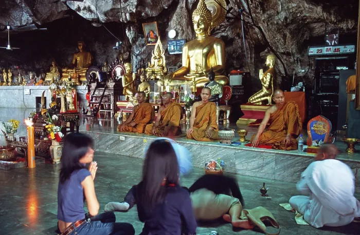 Framed Print : Buddha statue, monks and believers praying