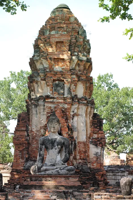 Framed Print : A Buddha statue seated before an ancient brick stupa Framed Print : A Buddha statue seated before an ancient brick stupa