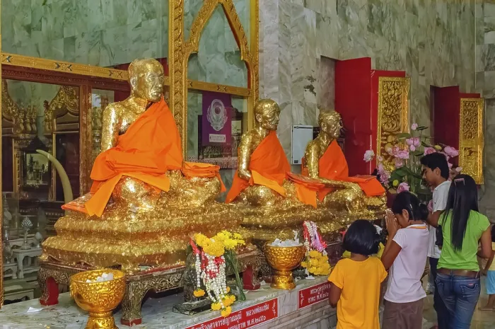 Framed Print : Buddhist believers Buddhists pray making offerings to statues of Buddhist monks covered with gold leaf at Wat Chalong Framed Print : Buddhist believers Buddhists pray making offerings to statues of Buddhist monks covered with gold leaf at Wat Chalong