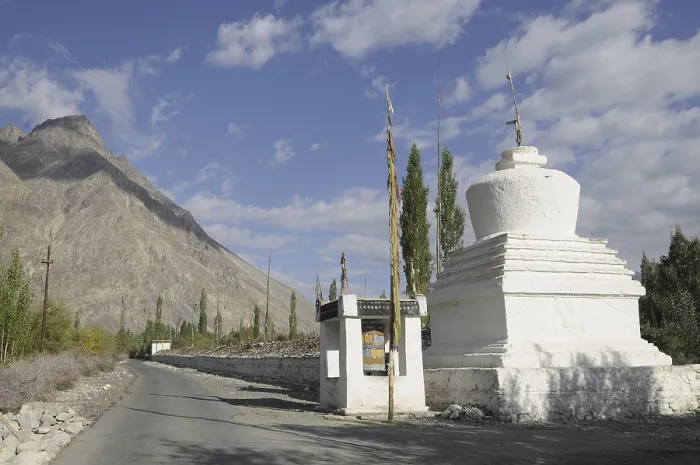 Framed Print : Buddhist chorten with a very long Mani wall beside the road in the Hundar oasis Framed Print : Buddhist chorten with a very long Mani wall beside the road in the Hundar oasis
