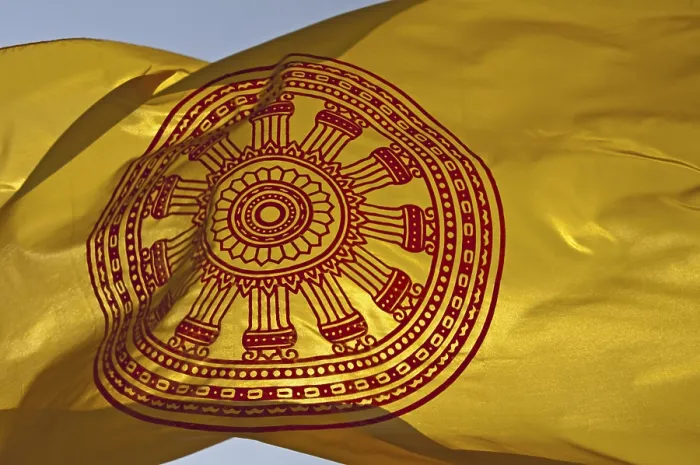 Framed Print : Buddhist flag with the Dharmacakra wheel symbolizing the Buddha's teachings
