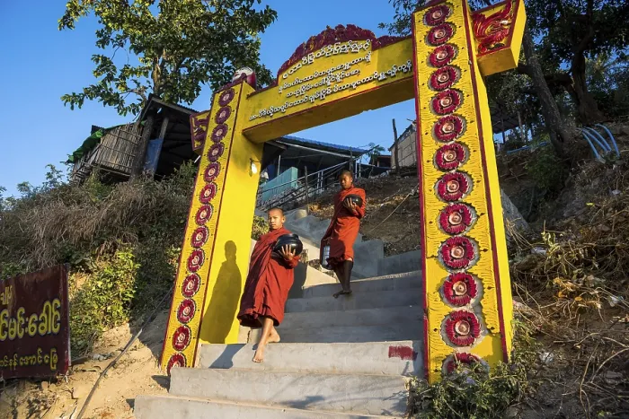 Framed Print : Buddhist novices with begging bowls at their morning begging tour