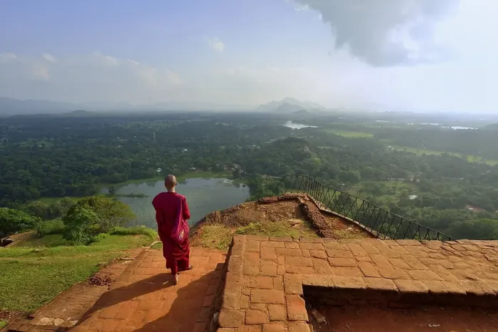 Framed Print : Buddhist nun enjoying the view from the ruins of the fortress on the Lion Rock