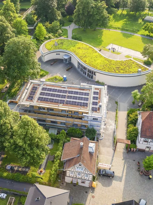 Framed Print : Building under construction with solar modules and green roof