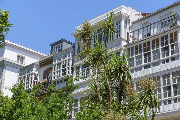 Framed Print : Building with large windows and palm trees in the foreground