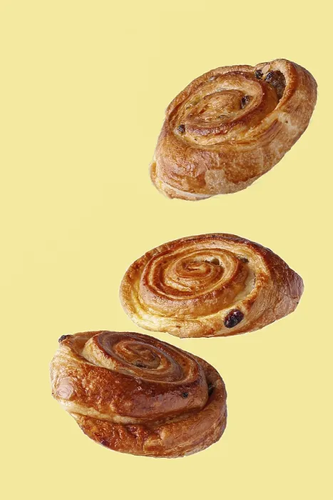 Framed Print : Buns with raisins flying food selective focus on yellow background