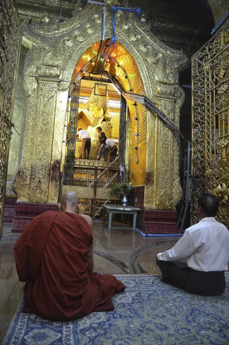 Framed Print : Burmese monk and a devout elderly man sitting in prayer in front of the most holy Buddha statue of the country
