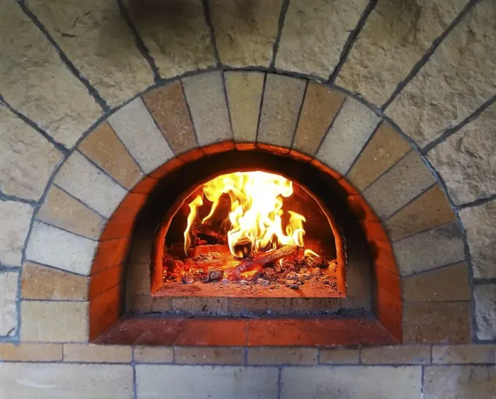 Framed Print : Burning firewood in traditional oven at restaurant kitchen