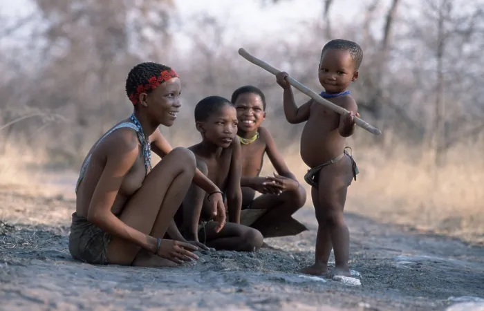 Framed Print : Bushman woman with children, child plays with stick Framed Print : Bushman woman with children, child plays with stick