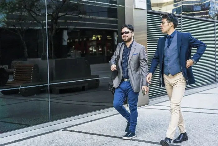 Framed Print : Two business colleagues are talking while walking on the street Framed Print : Two business colleagues are talking while walking on the street