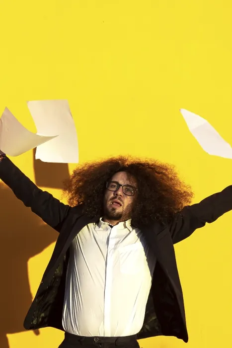 Framed Print : Business man throwing documents in the air on isolated background Framed Print : Business man throwing documents in the air on isolated background