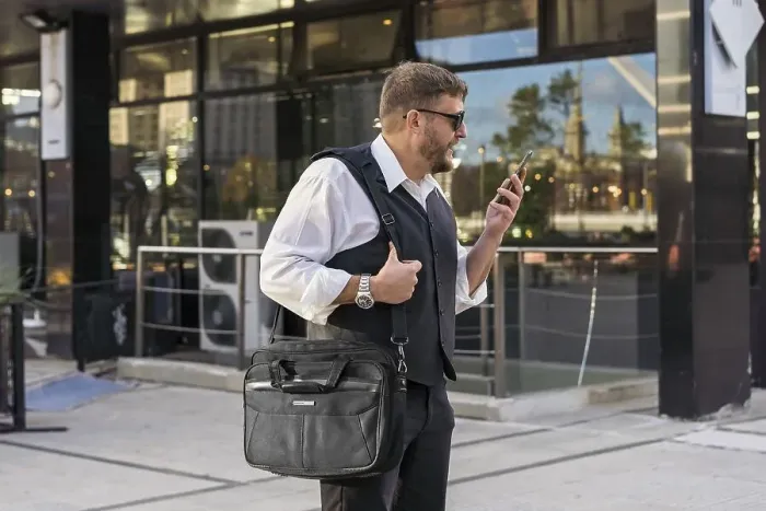 Framed Print : A businessman leaving a message to his friend before entering an after-office