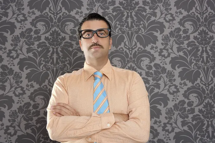 Framed Print : Businessman nerd portrait with retro glasses over wallpaper background Framed Print : Businessman nerd portrait with retro glasses over wallpaper background