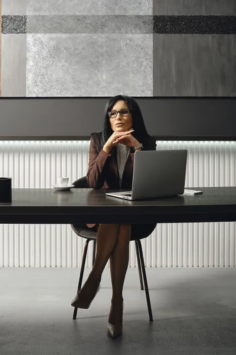 Framed Print : A businesswoman sits at a sleek desk in a contemporary office