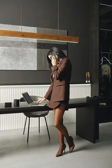 Framed Print : A businesswoman stands in a modern office space
