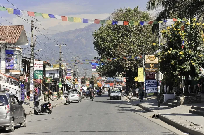 Framed Print : Busy street in a Nepalese town with shops and fluttering prayer flags