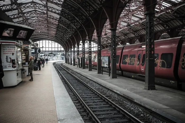 Framed Print : Busy train station with red trains and passengers waiting on the platform in Copenhagen