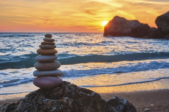 Framed Print : Cairn stack of stones pebbles cairn on the beach coast of the seaon sunset