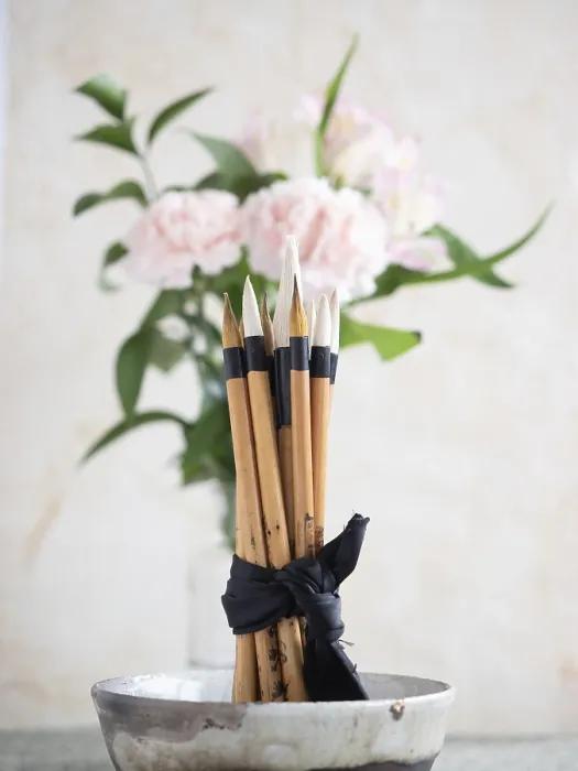 Framed Print : Calligraphy brushes are tied with a black ribbon and placed in a ceramic bowl