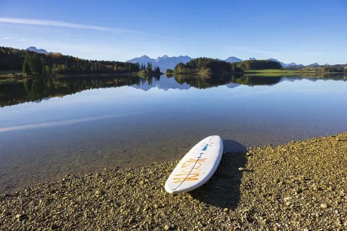 Framed Print : A calm lake with a surfboard on the shore Framed Print : A calm lake with a surfboard on the shore