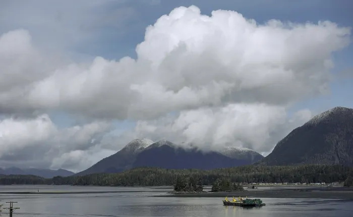 Framed Print : Calm lake waters with mountain backdrop and clouds in a blue sky in Tofino