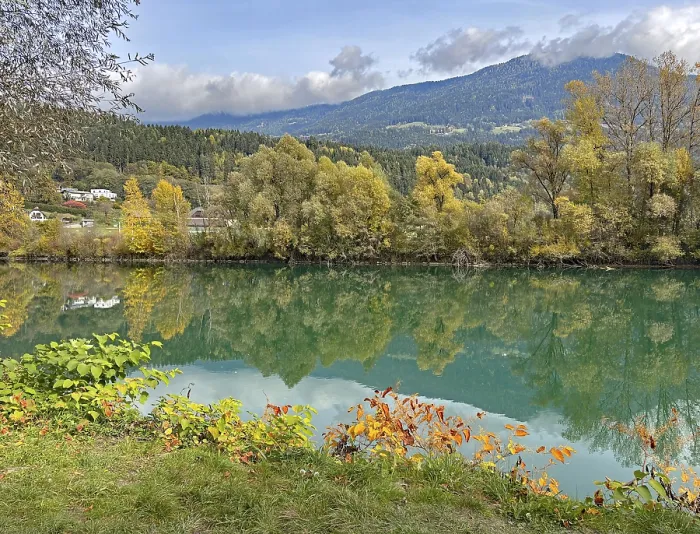 Framed Print : Calm river reflecting autumnal trees and mountains under cloudy sky Framed Print : Calm river reflecting autumnal trees and mountains under cloudy sky