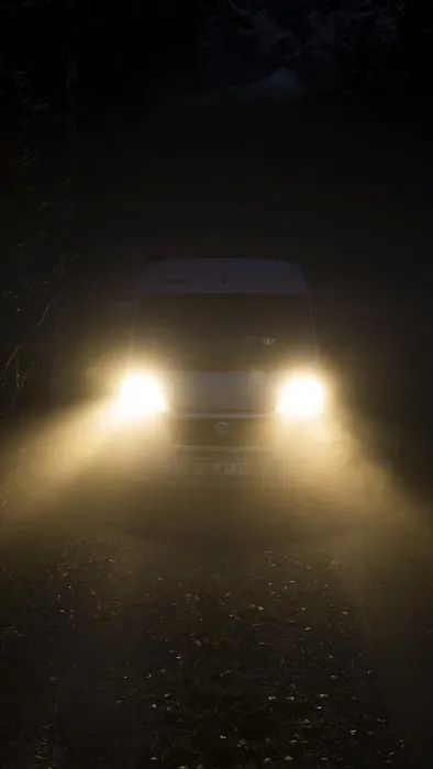 Framed Print : Campervan with bright lights standing in the fog
