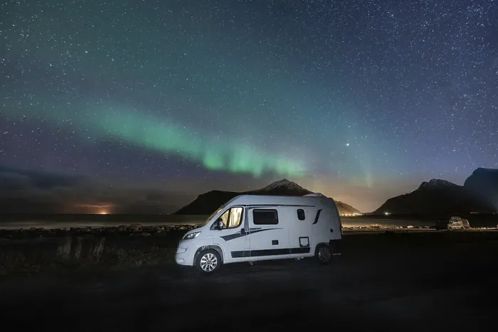 Framed Print : Campervan stands at Flakstad beach with northern lights